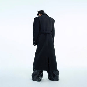 Close-up detail of stylish metal buttons on oversized wool trench coat with deconstructed design