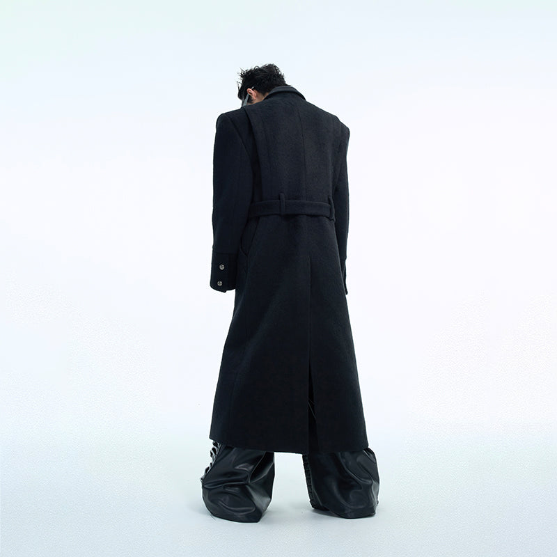 Close-up detail of stylish metal buttons on oversized wool trench coat with deconstructed design