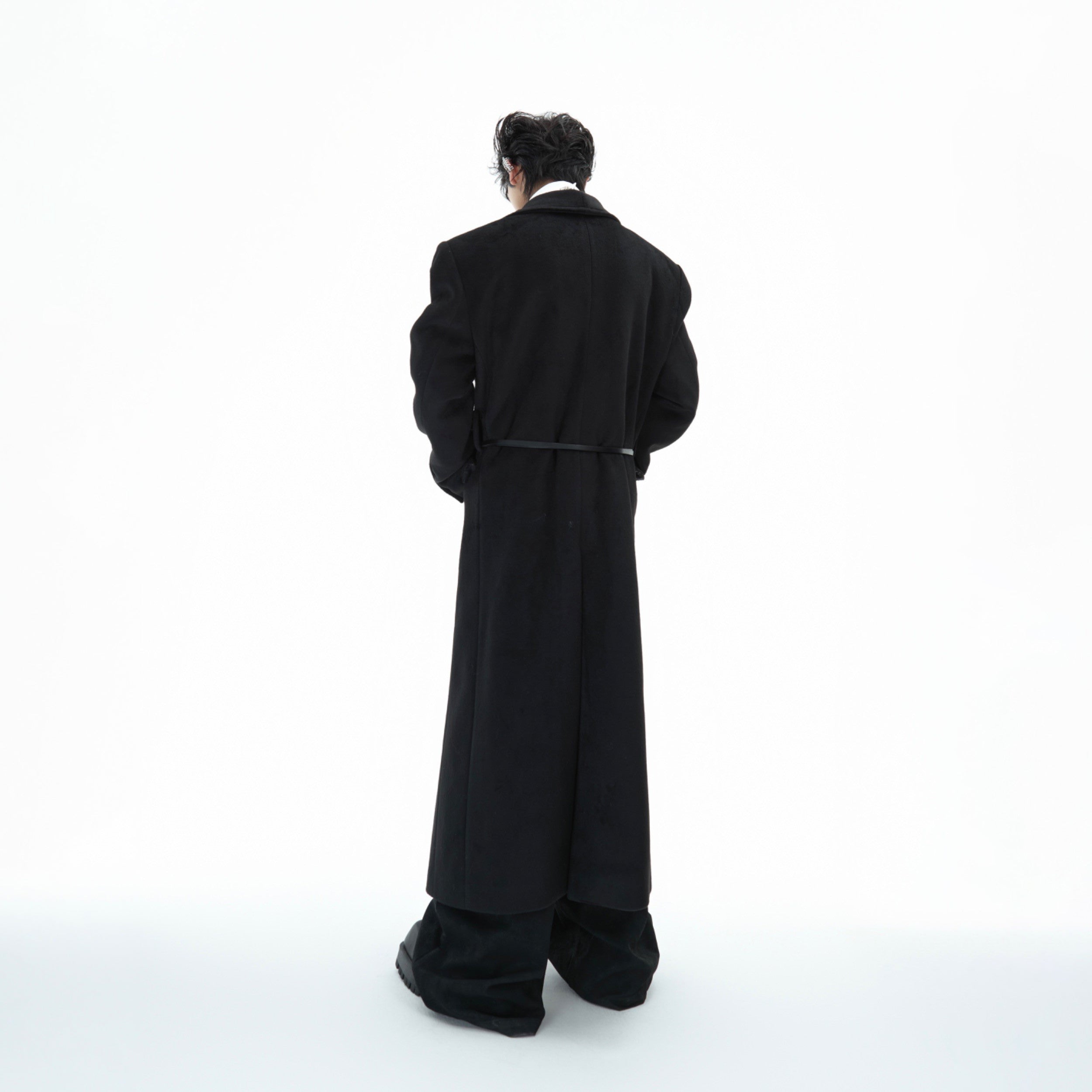 Back view of the fashion-forward wool coat featuring its unique deconstructed tailoring