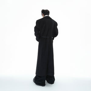 Back view of the fashion-forward wool coat featuring its unique deconstructed tailoring