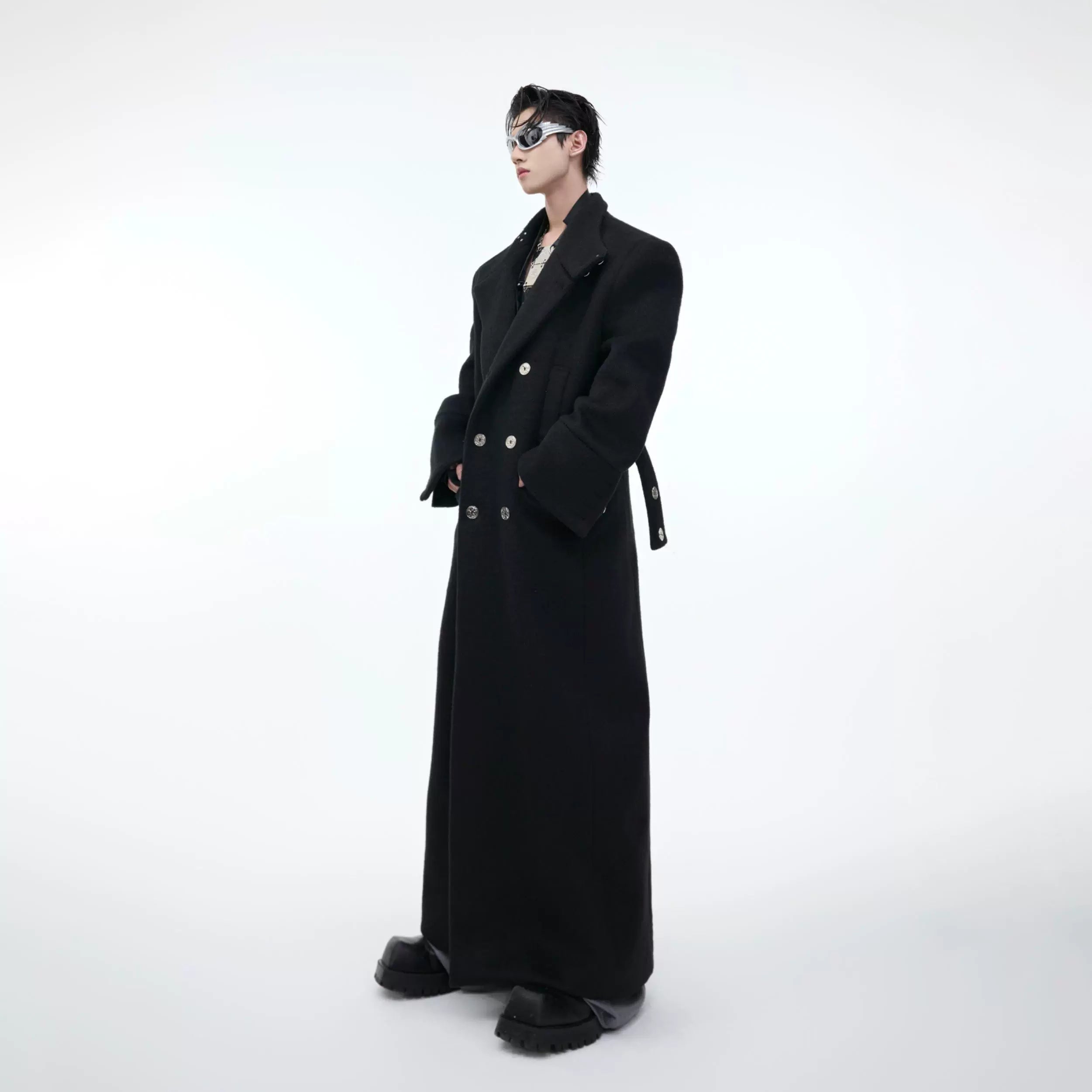 Close-up of the metal buckle detailing on premium wool long trench coat with stand collar