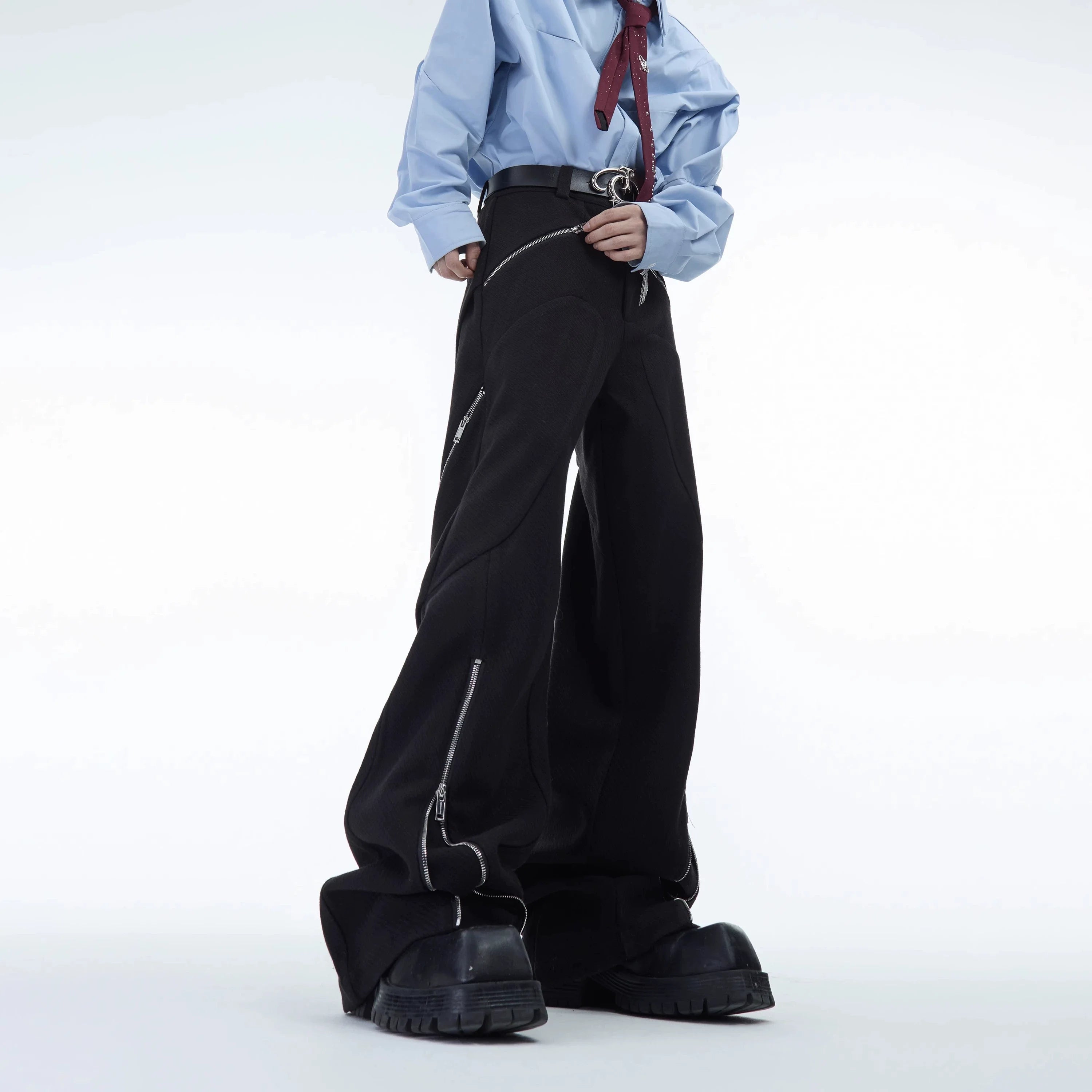 High-waisted wool trousers with distinctive metal zipper details and loose streetwear fit