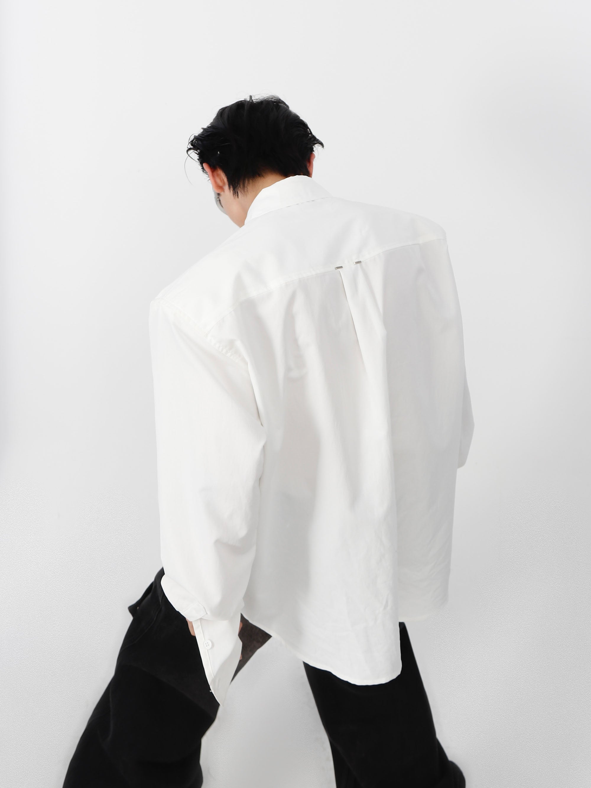 Close-up of unique wrinkle design and open front on this avant-garde cotton shirt for men
