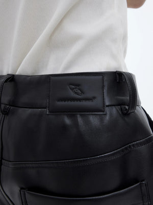 Back view of black flared leather pants with matte finish