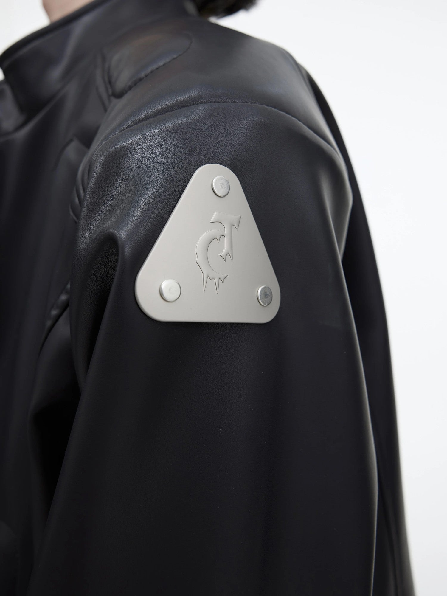 Side profile of a stand collar futuristic streetwear jacket in black