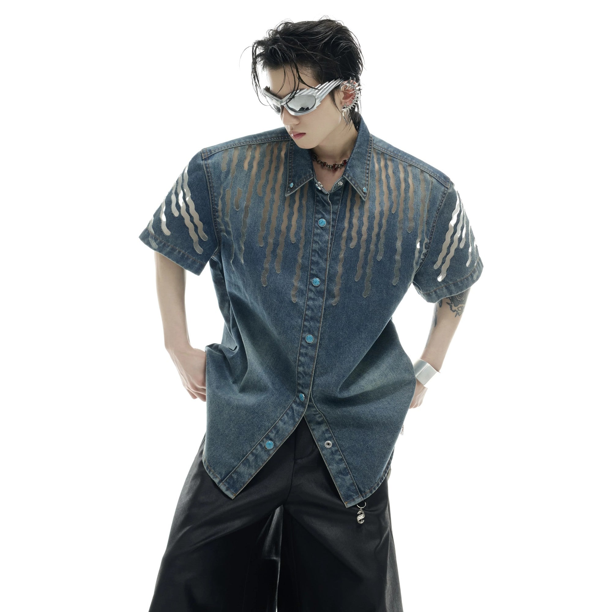 Close-up of mesh paneling and distressed wash on denim short-sleeve jacket