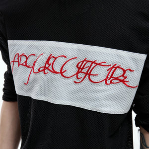 Close up of high-density red script embroidery on mesh fabric
