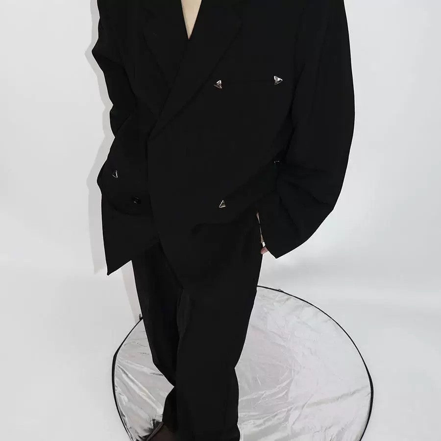 Front view of an oversized black streetwear blazer with metal hardware details