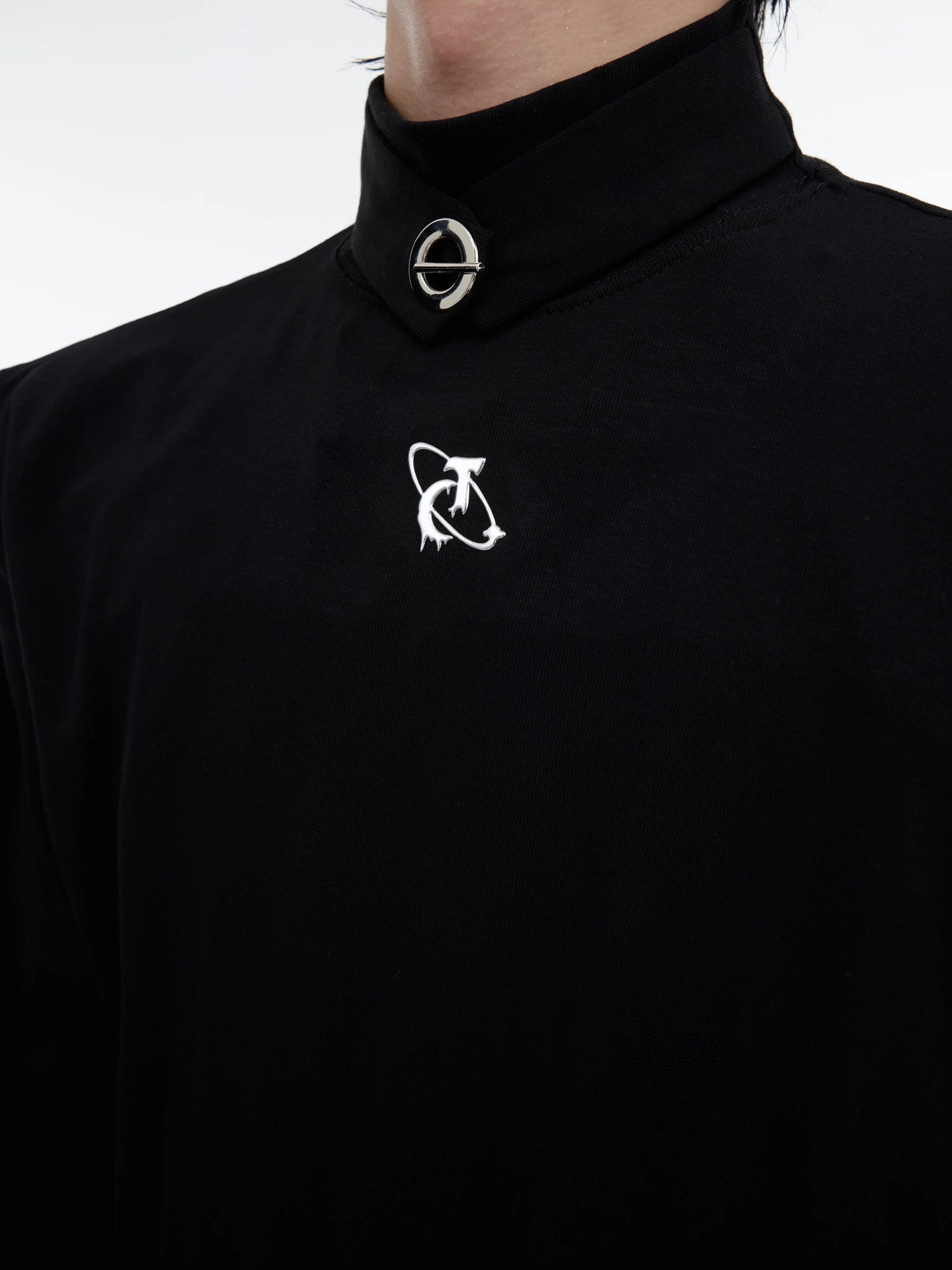 Close up of the metal hardware and brand logo on the turtleneck collar