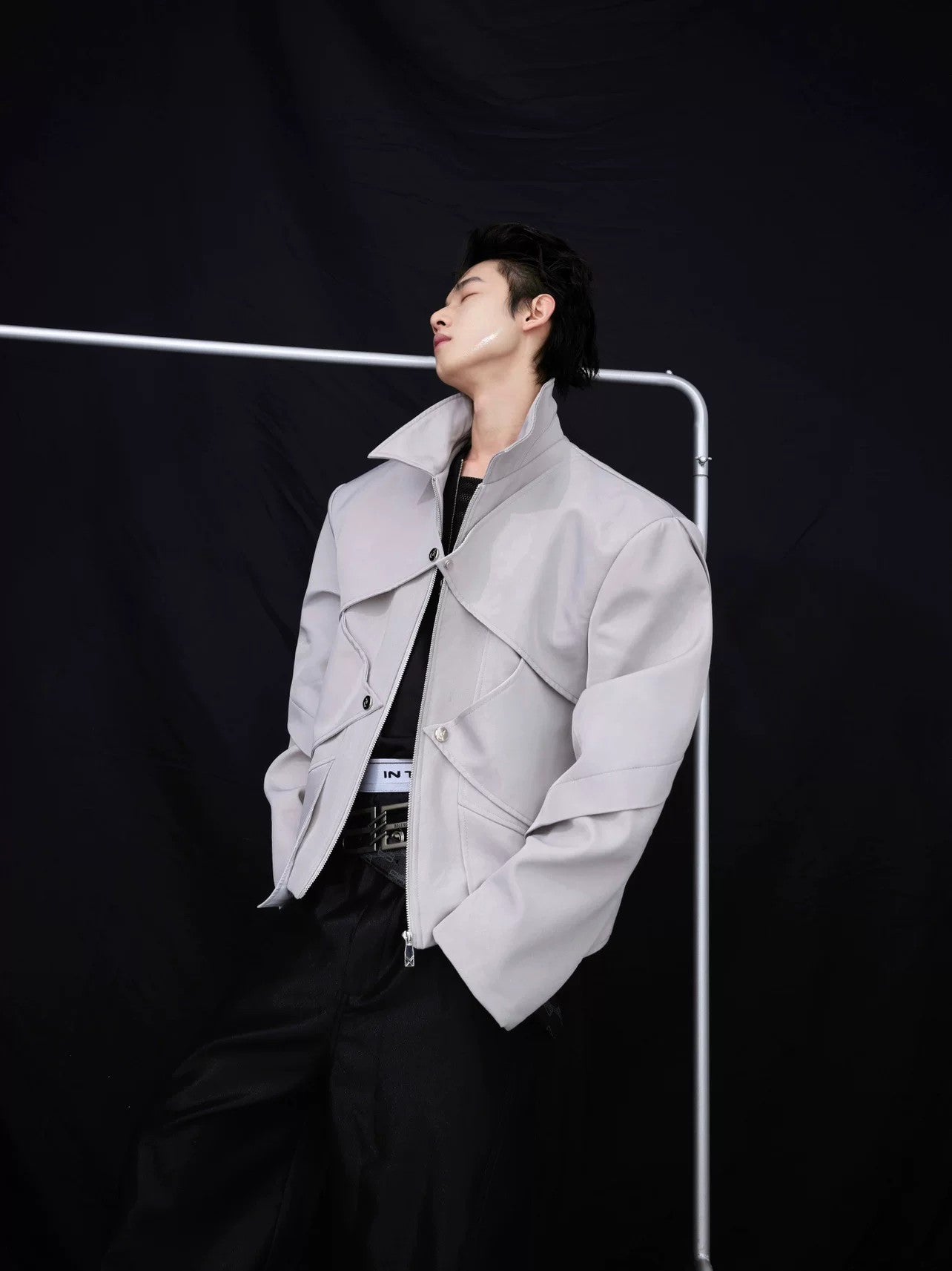 Front view of a silver liquid metal avant-garde cropped jacket for men