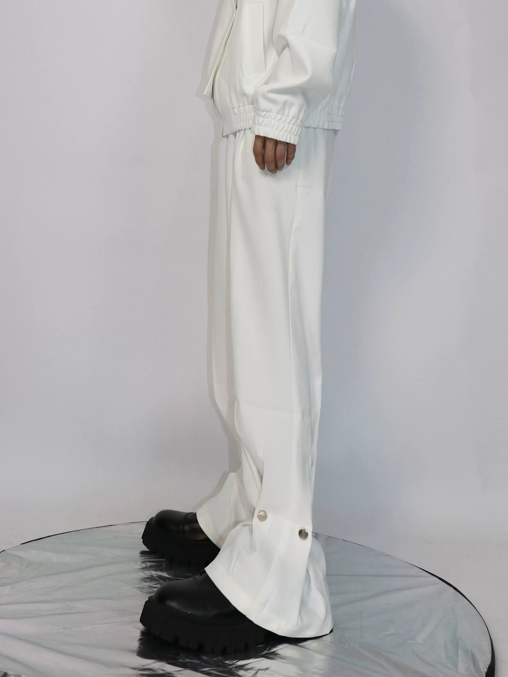 Men's minimalist white straight-leg trousers with metal button detail