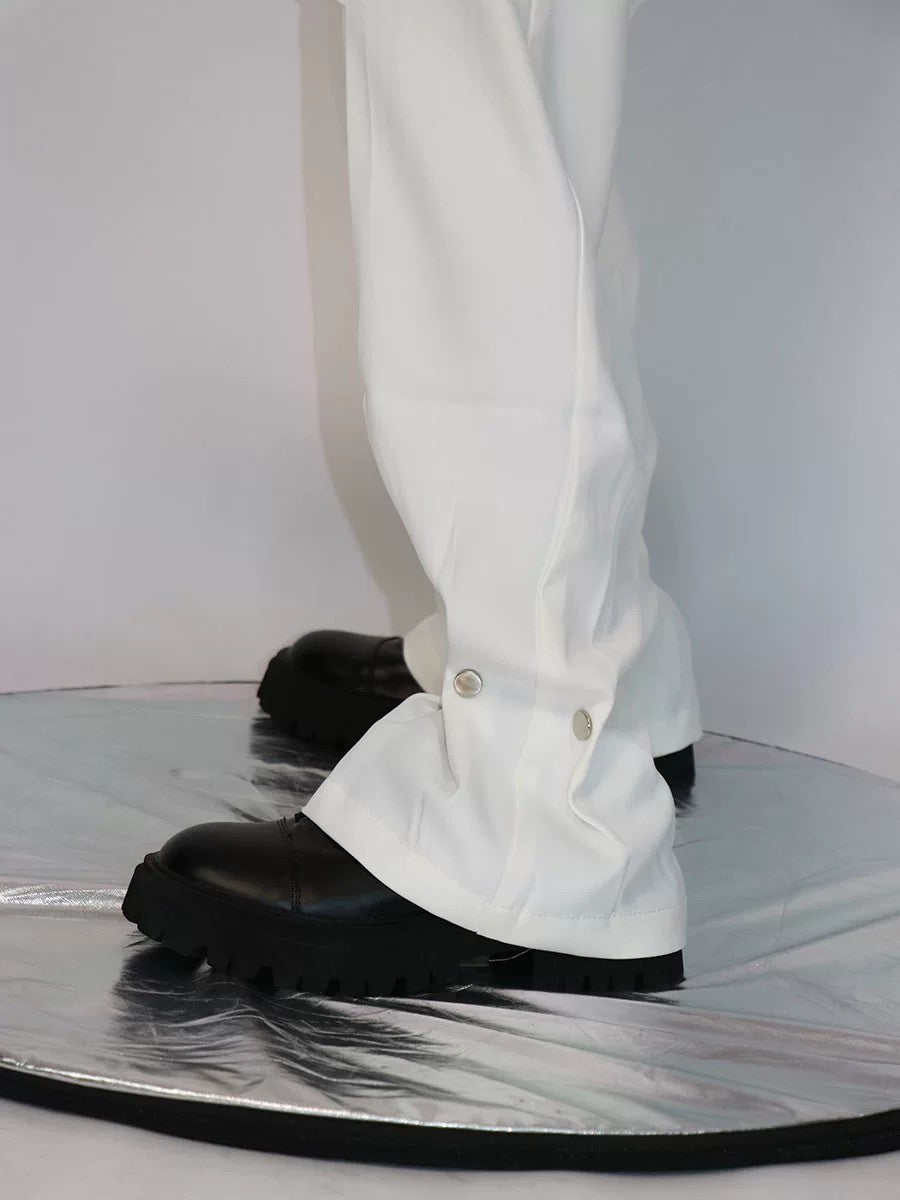 Close-up of high-end metal button design on white casual trousers