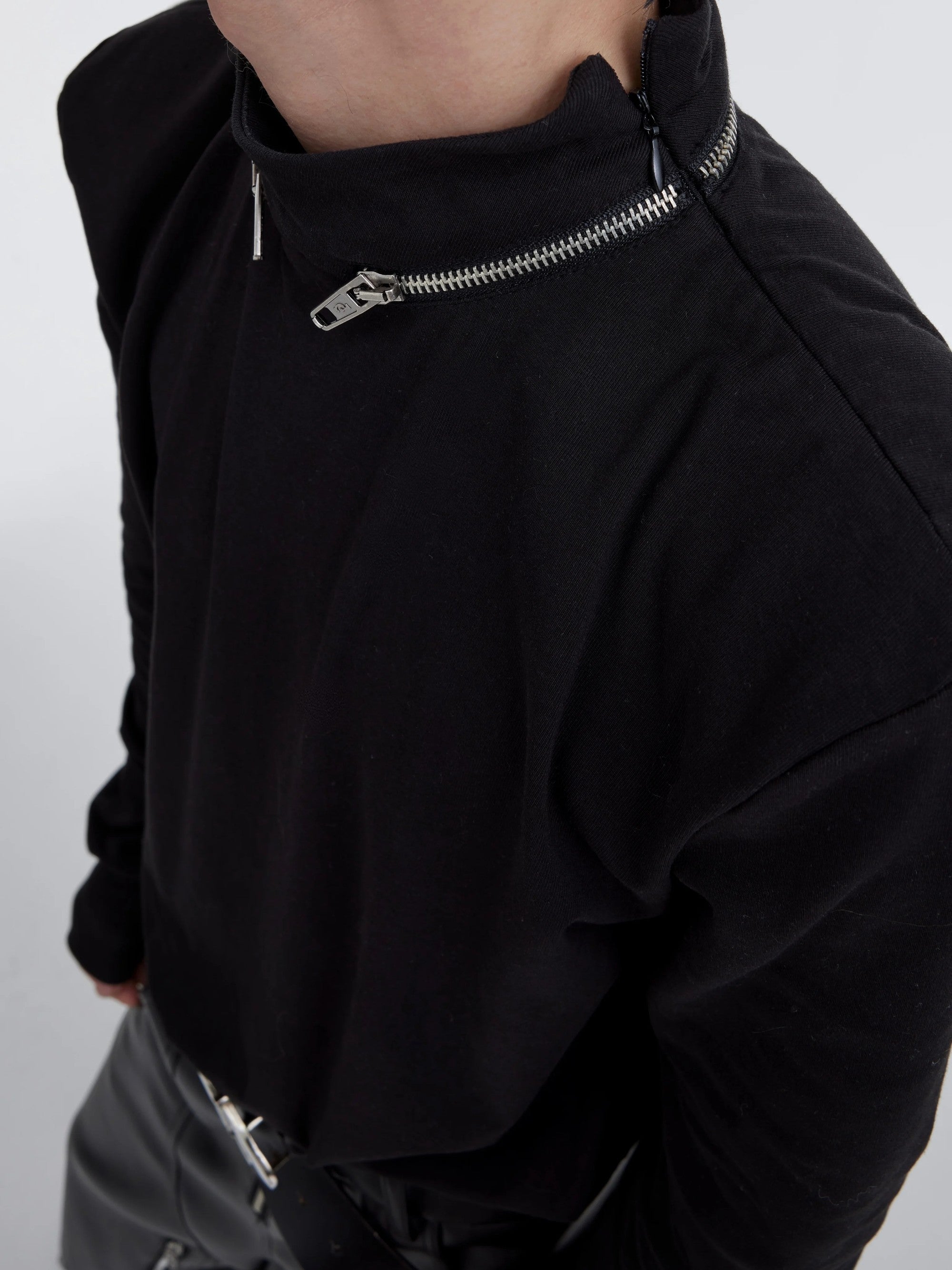 Structural print detail on the sleeve of a black streetwear undershirt