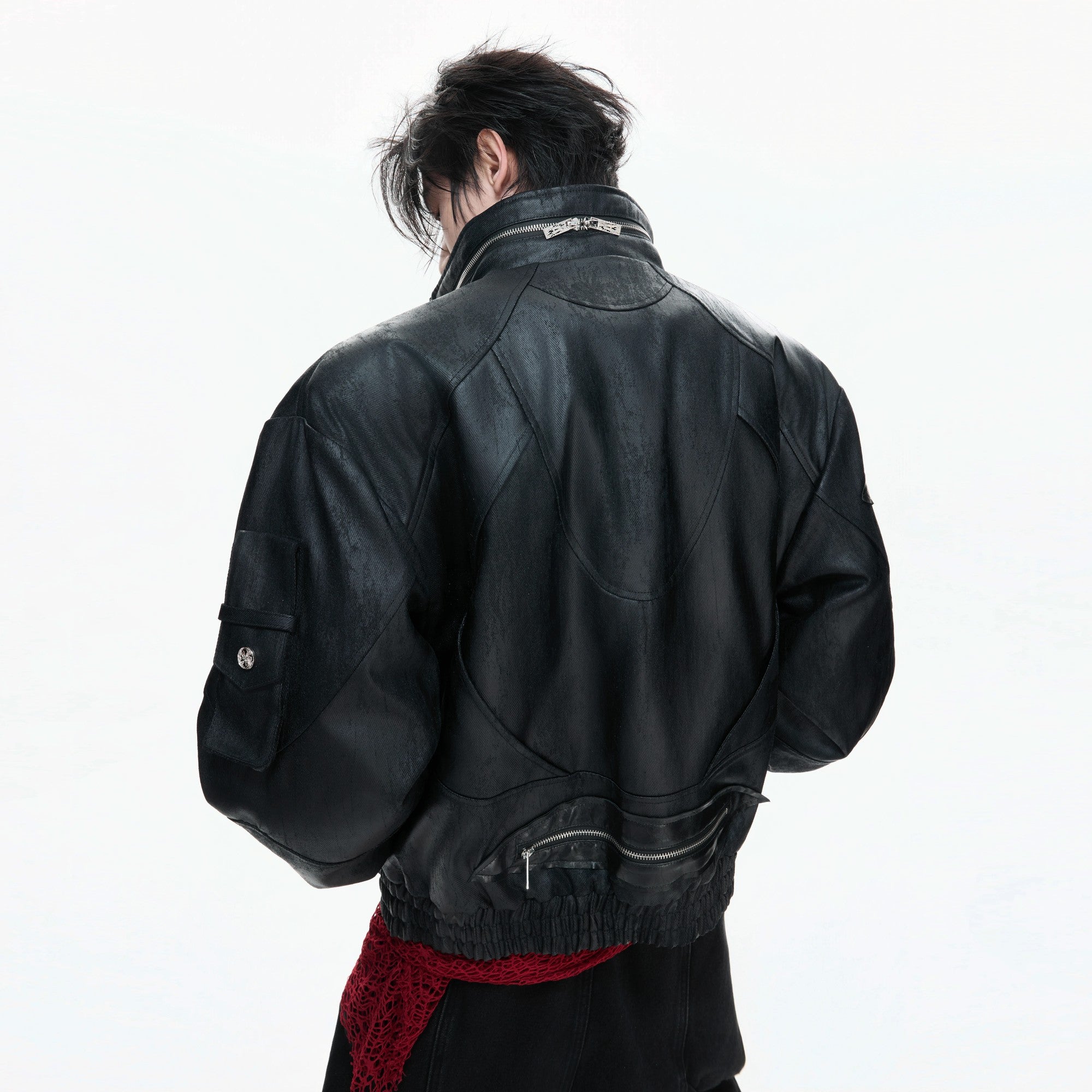 Close-up of metal zipper details and distressed oil-waxed leather texture