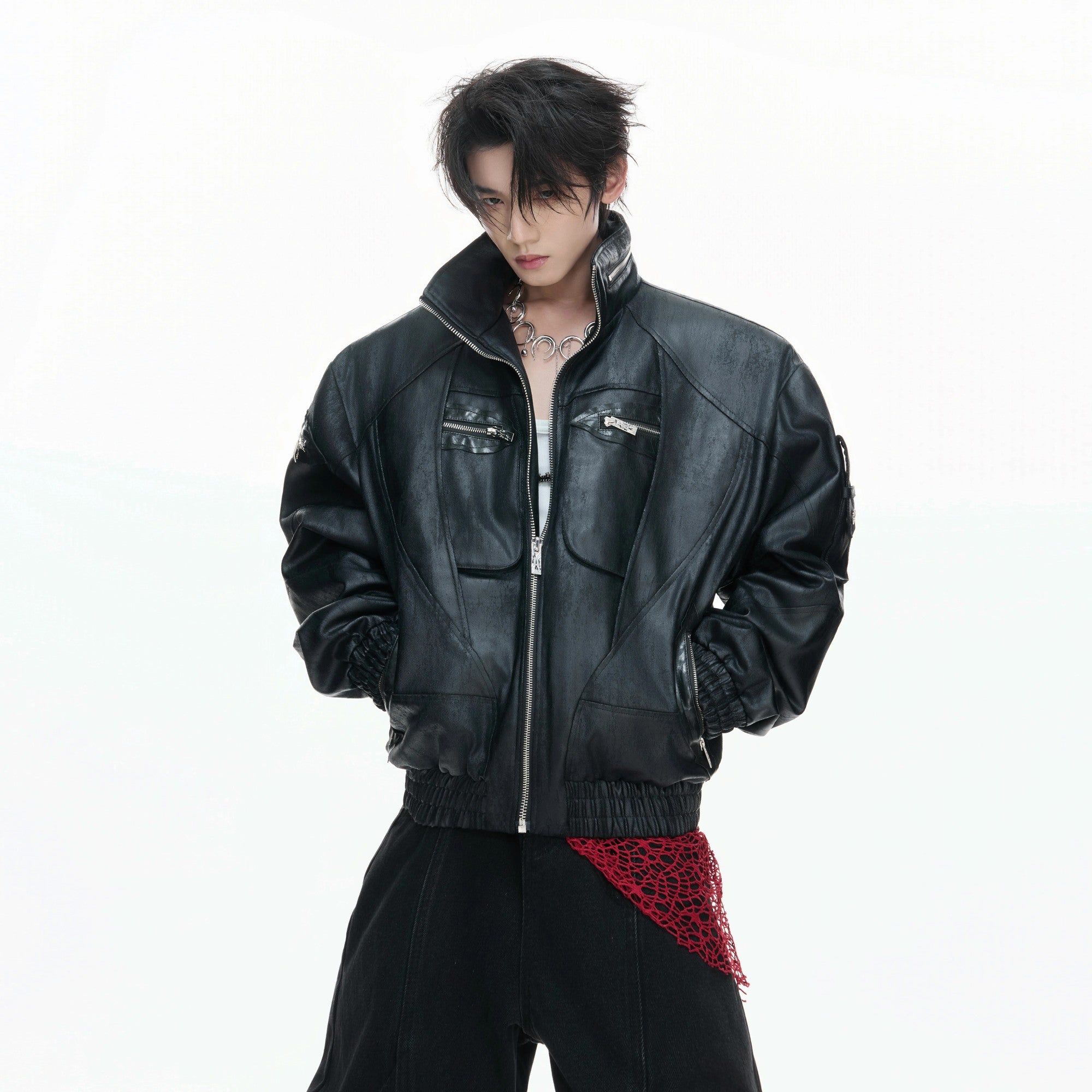 Model wearing a short-cut deconstructed leather jacket in a streetwear setting