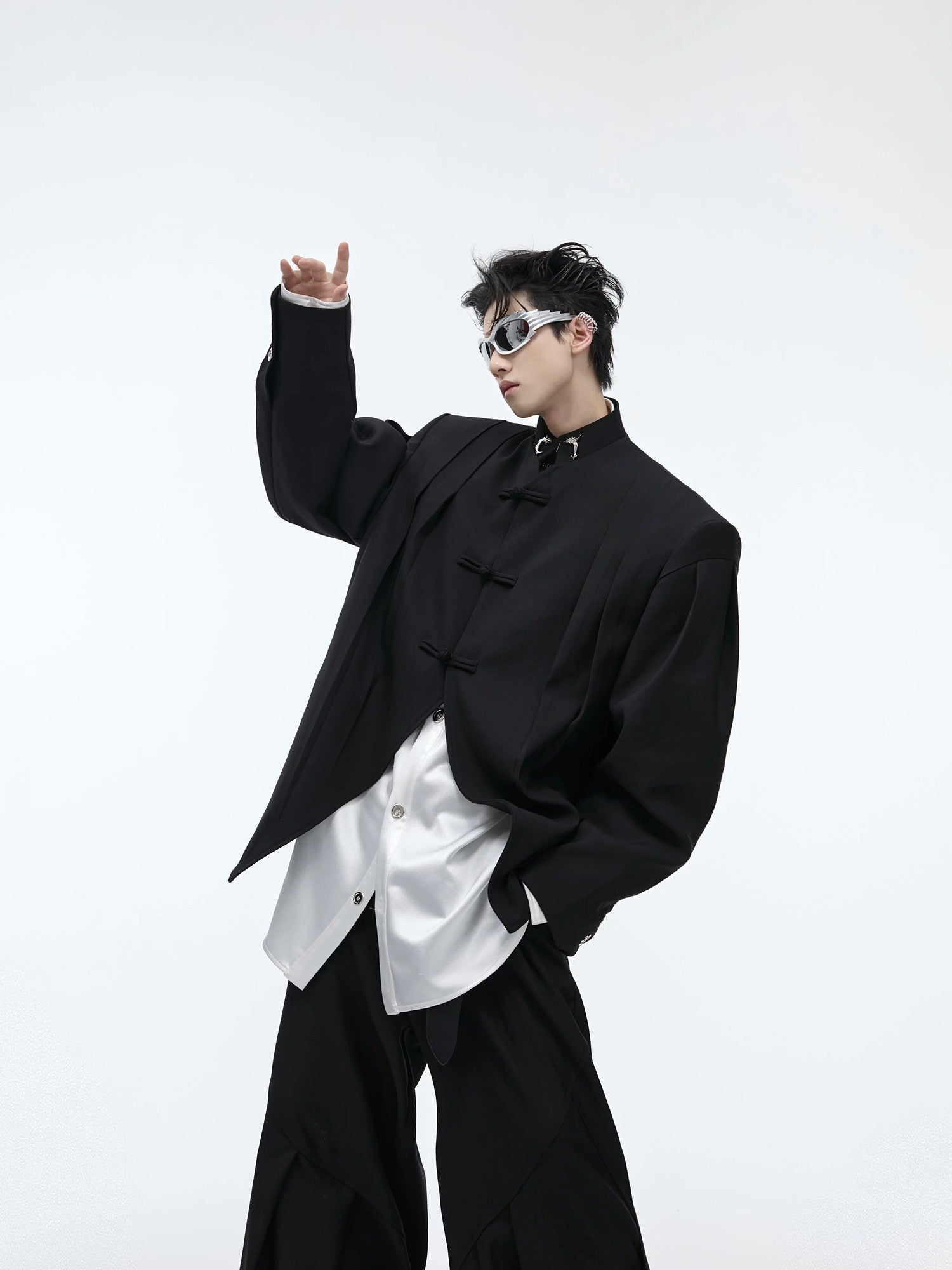 Close-up of traditional Chinese frog buttons on a pleated jacket