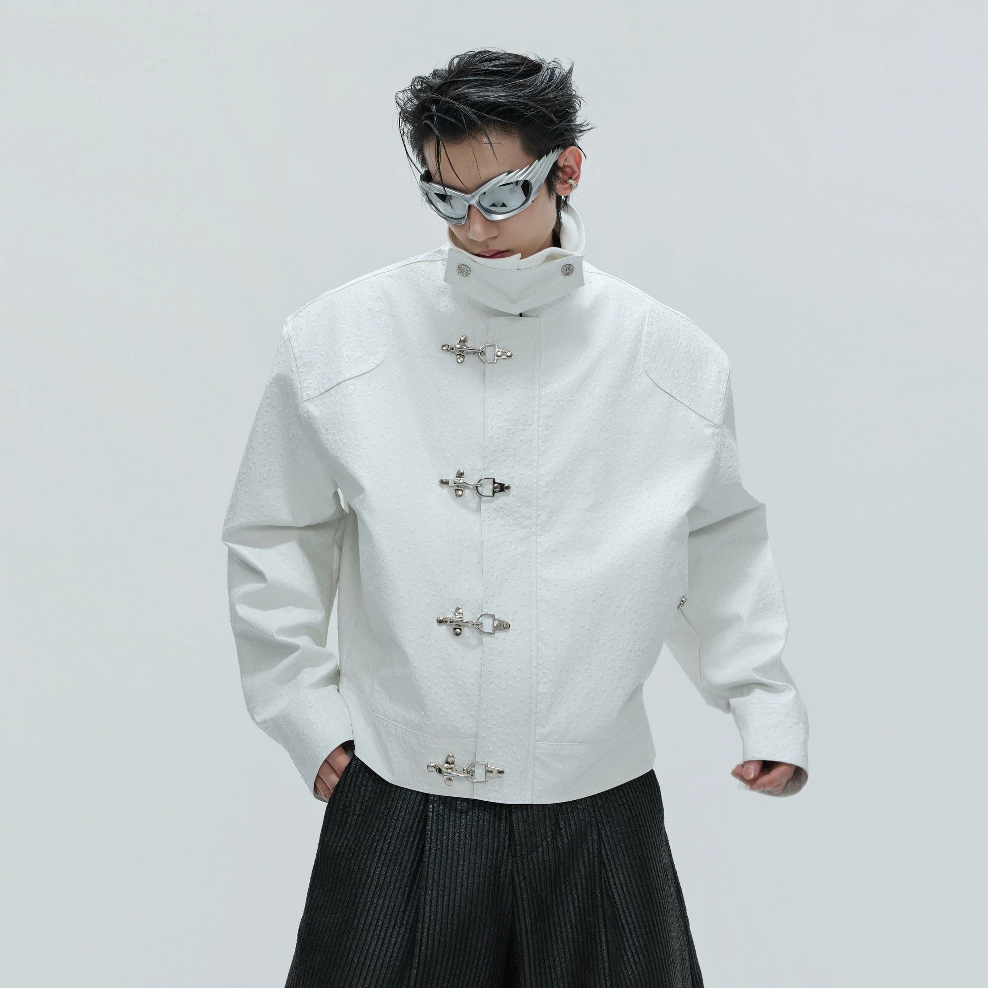 White winter leather jacket with ostrich pattern and deconstructed design.