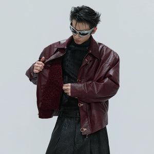 Bold red ostrich leather jacket featuring unique metal buckle closures.