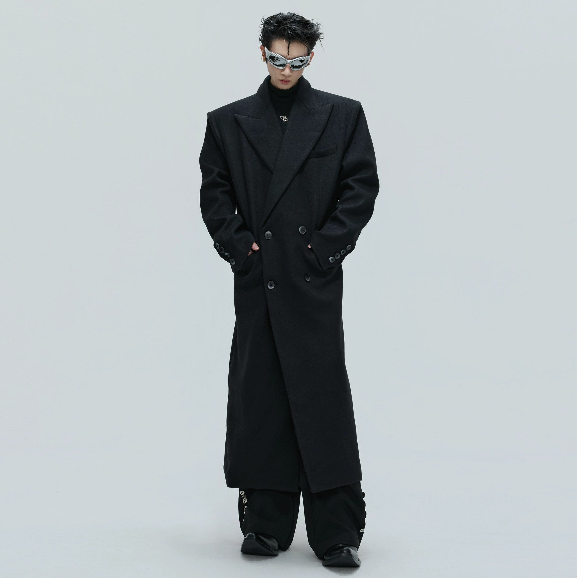 Front view of oversized black alpaca wool trench coat with double-breasted design