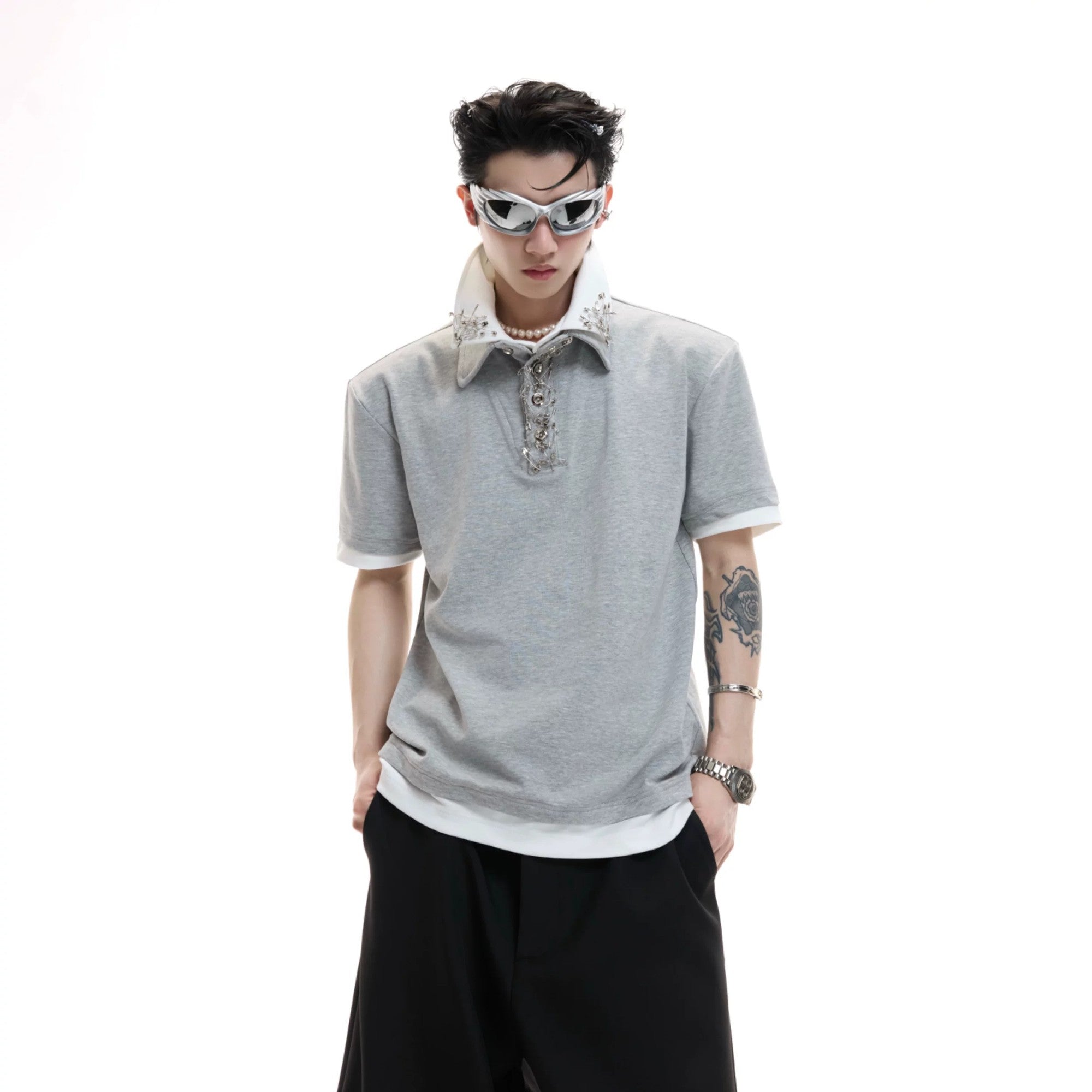 Front view of black oversized streetwear tee with contrast collar and metal pin.