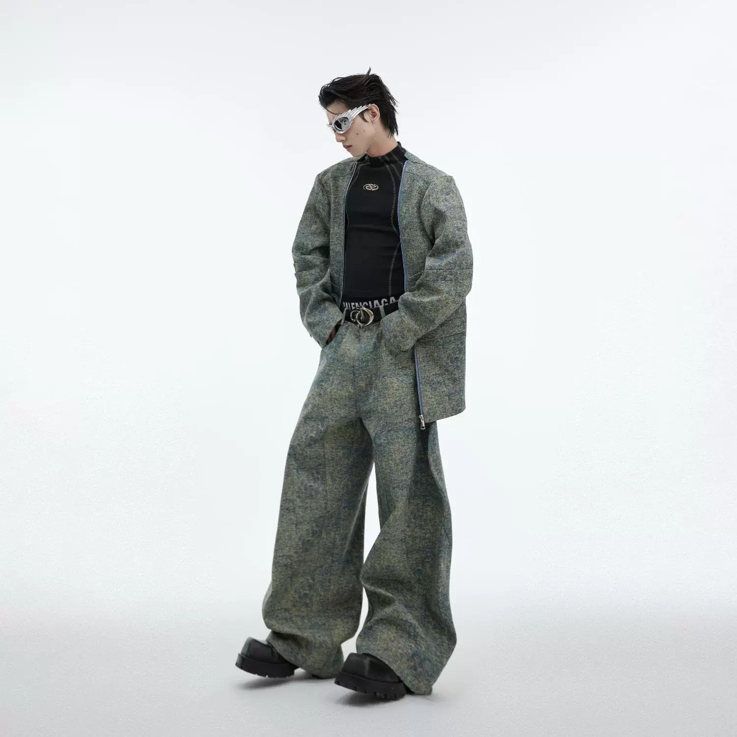 Model wearing a green deconstructed denim blazer with 3D texture and metal zips
