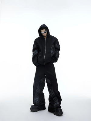 Front view of black deconstructed PU leather patchwork oversized tracksuit
