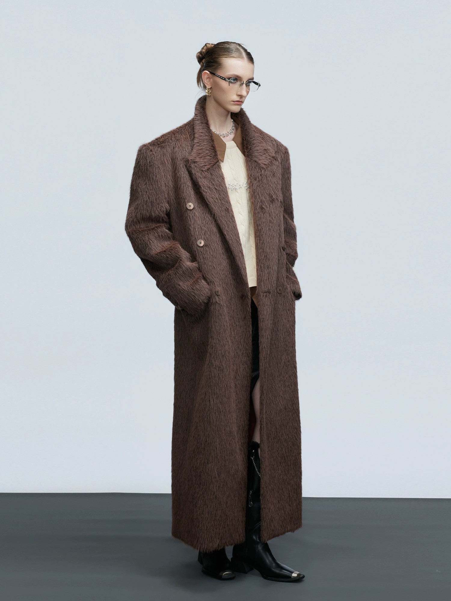 Back view showing the loose silhouette and drape of the long wool coat