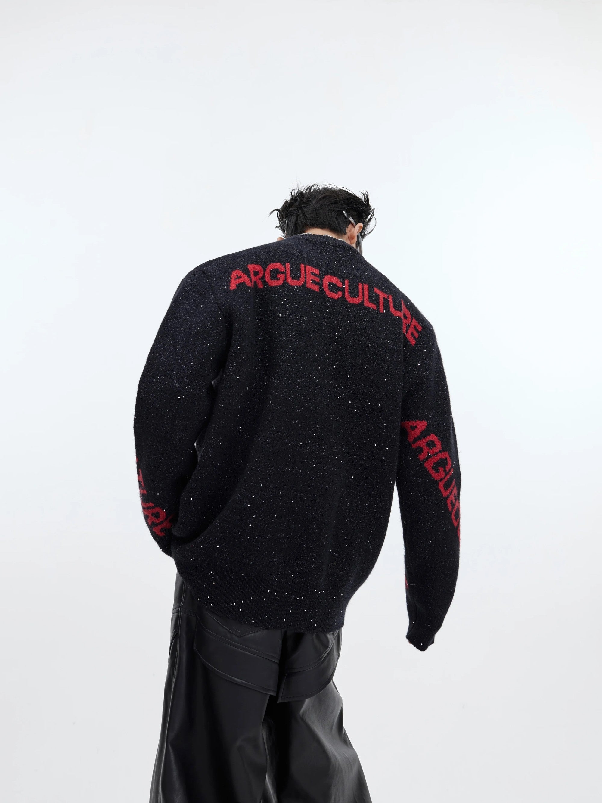 Front view of oversized black dragon graphic shimmer knit sweater