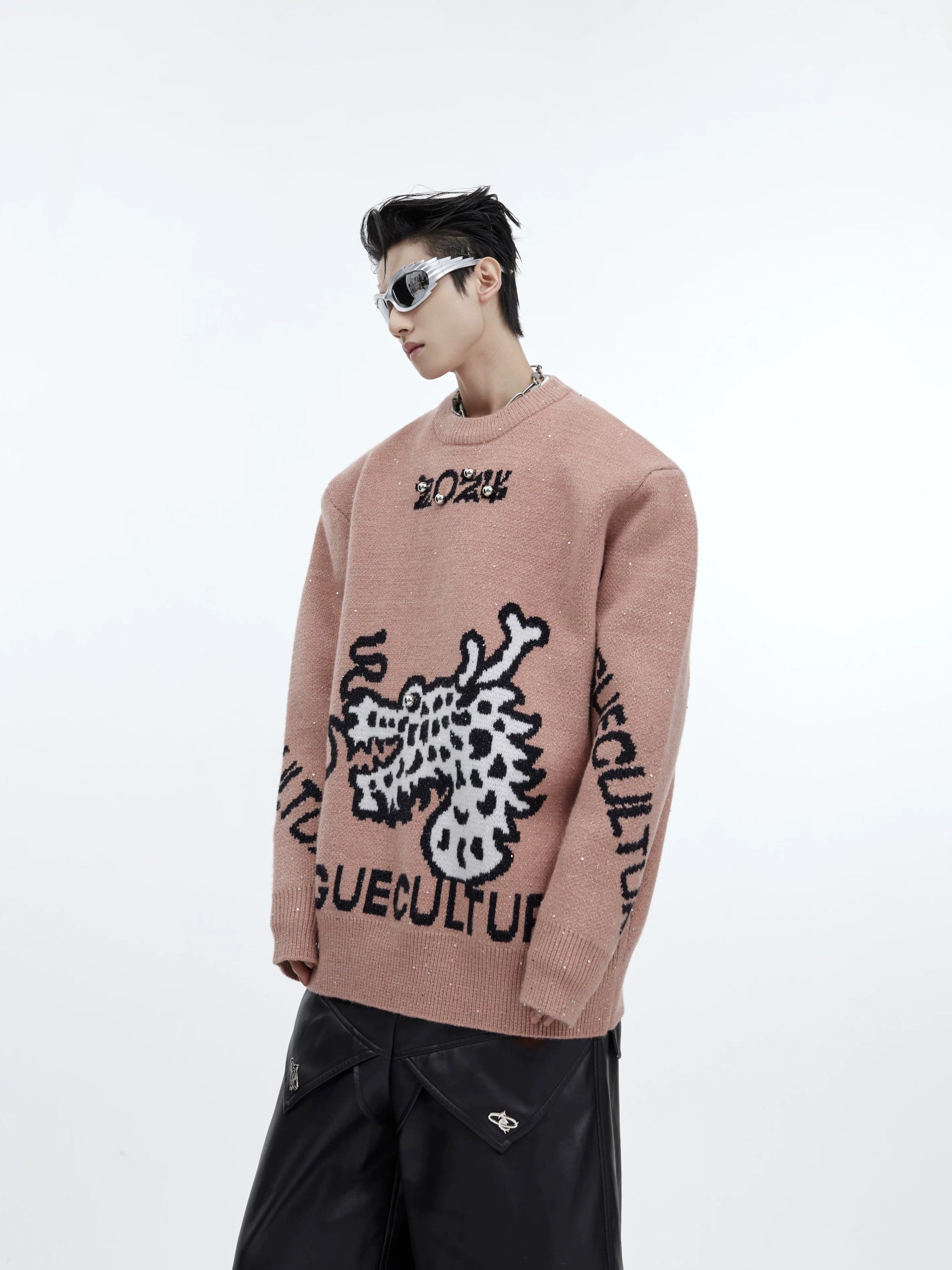 Lifestyle shot of pink shimmering dragon knit sweater for men and women