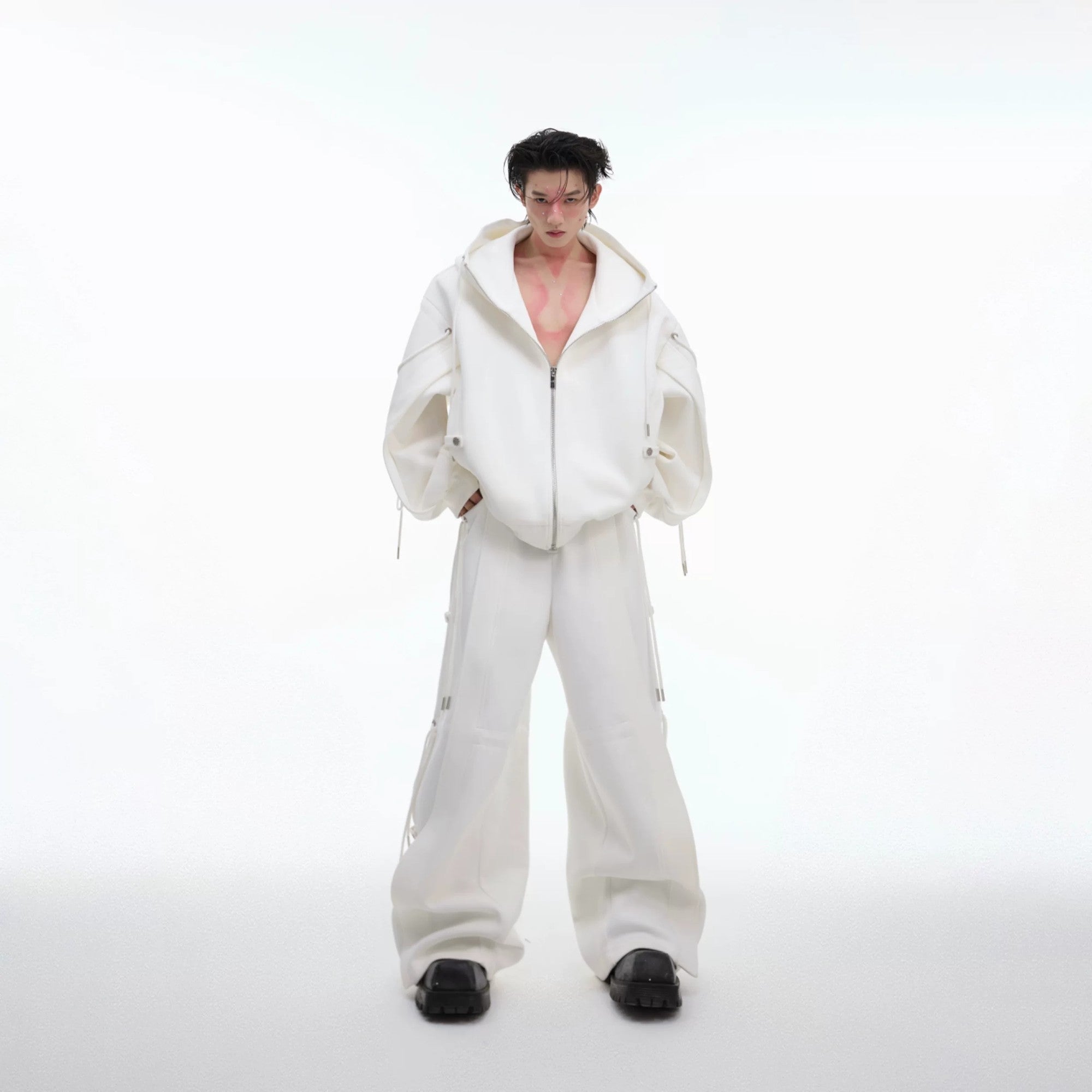 Model wearing a gray oversized deconstructed hoodie and wide-leg pants set