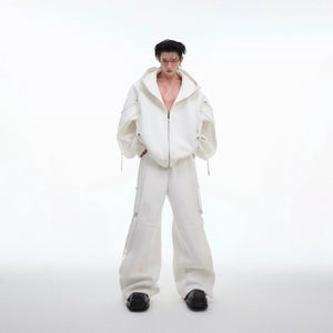 Model wearing a gray oversized deconstructed hoodie and wide-leg pants set