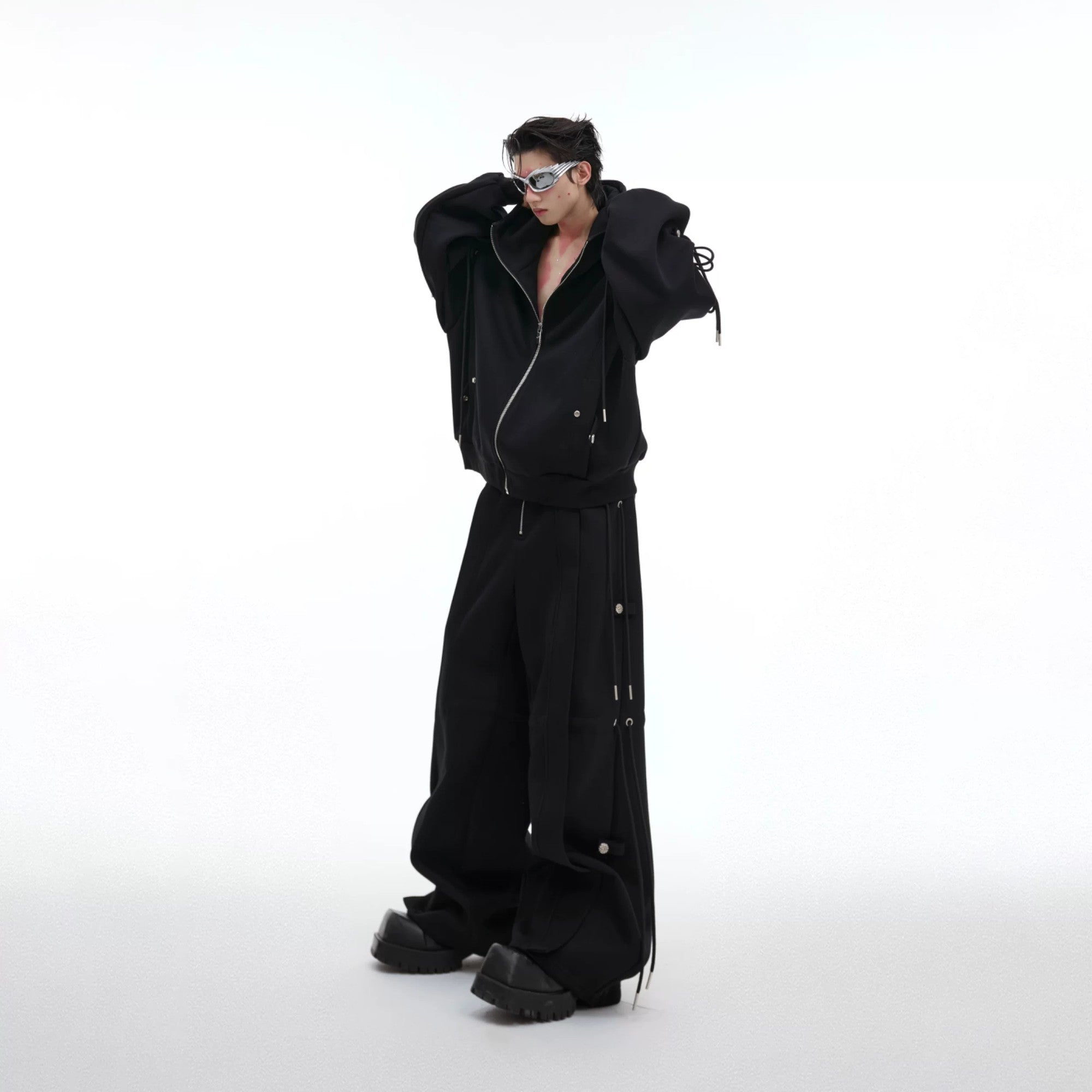 Close-up of the deconstructed drawstring design on a white streetwear hoodie