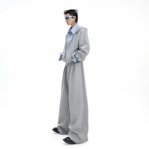 Streetwear model wearing the oversized layered hoodie set in gray