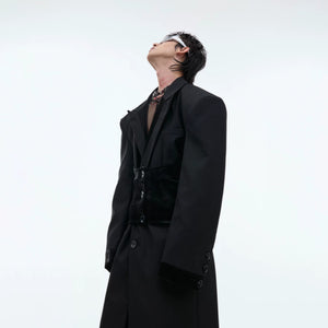 Side view showing the structured silhouette and long length of the black coat.