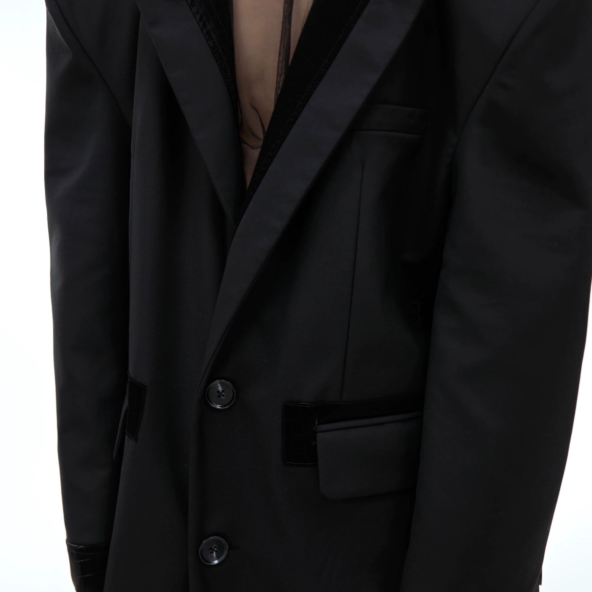 Back view of the deconstructed long coat showing the adjustable waist belt.