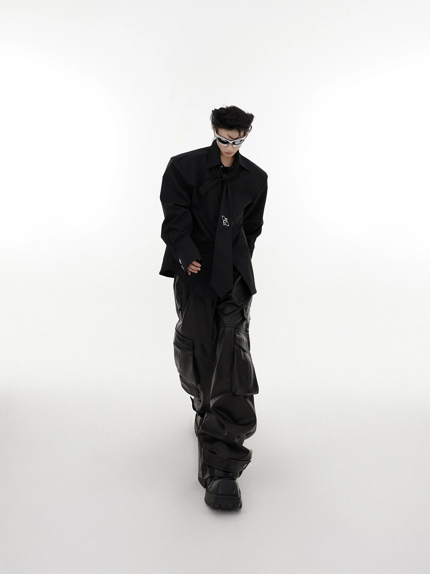 Model wearing a white padded shoulder shirt in an urban setting