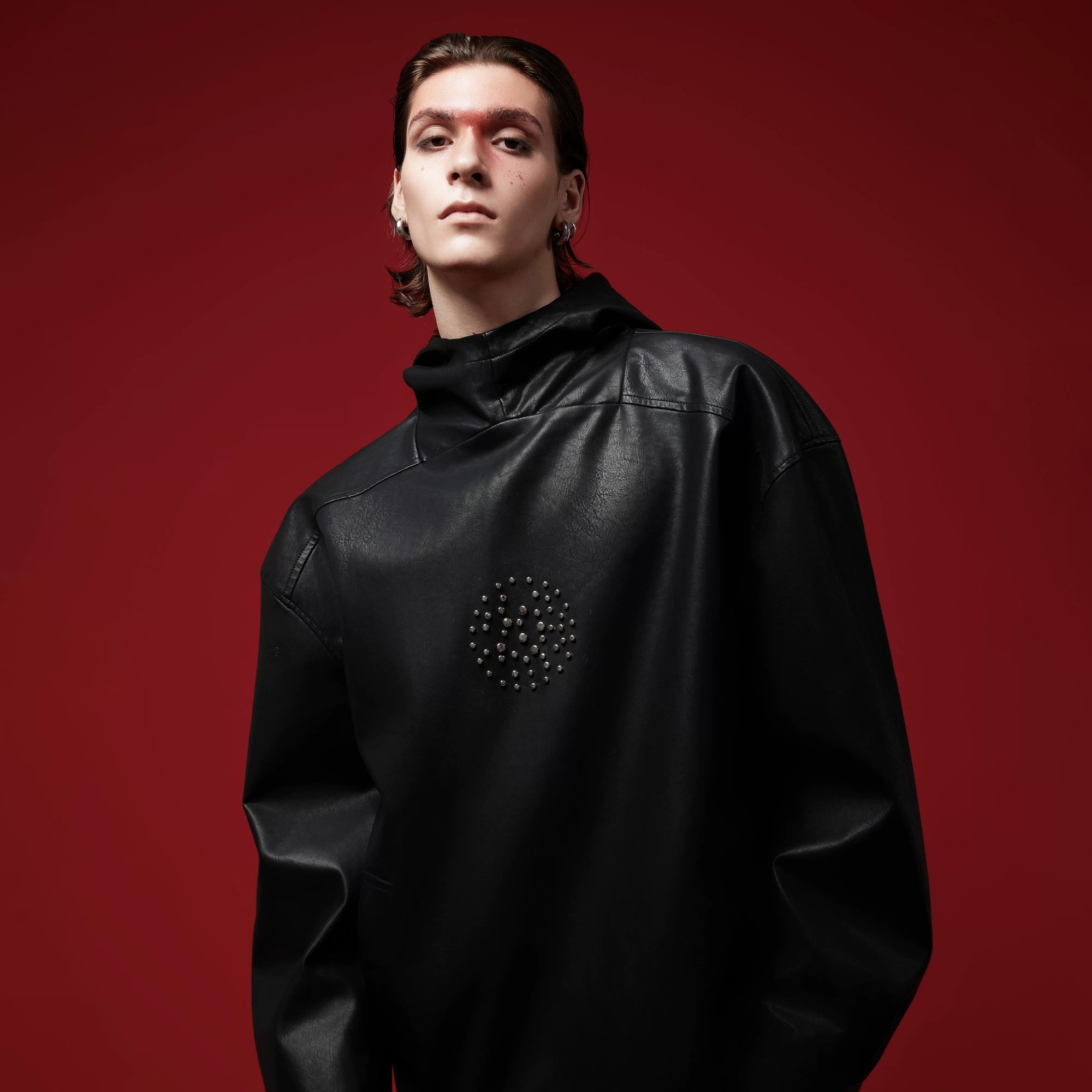 Lifestyle shot of gothic aesthetic faux leather hoodie with hood up