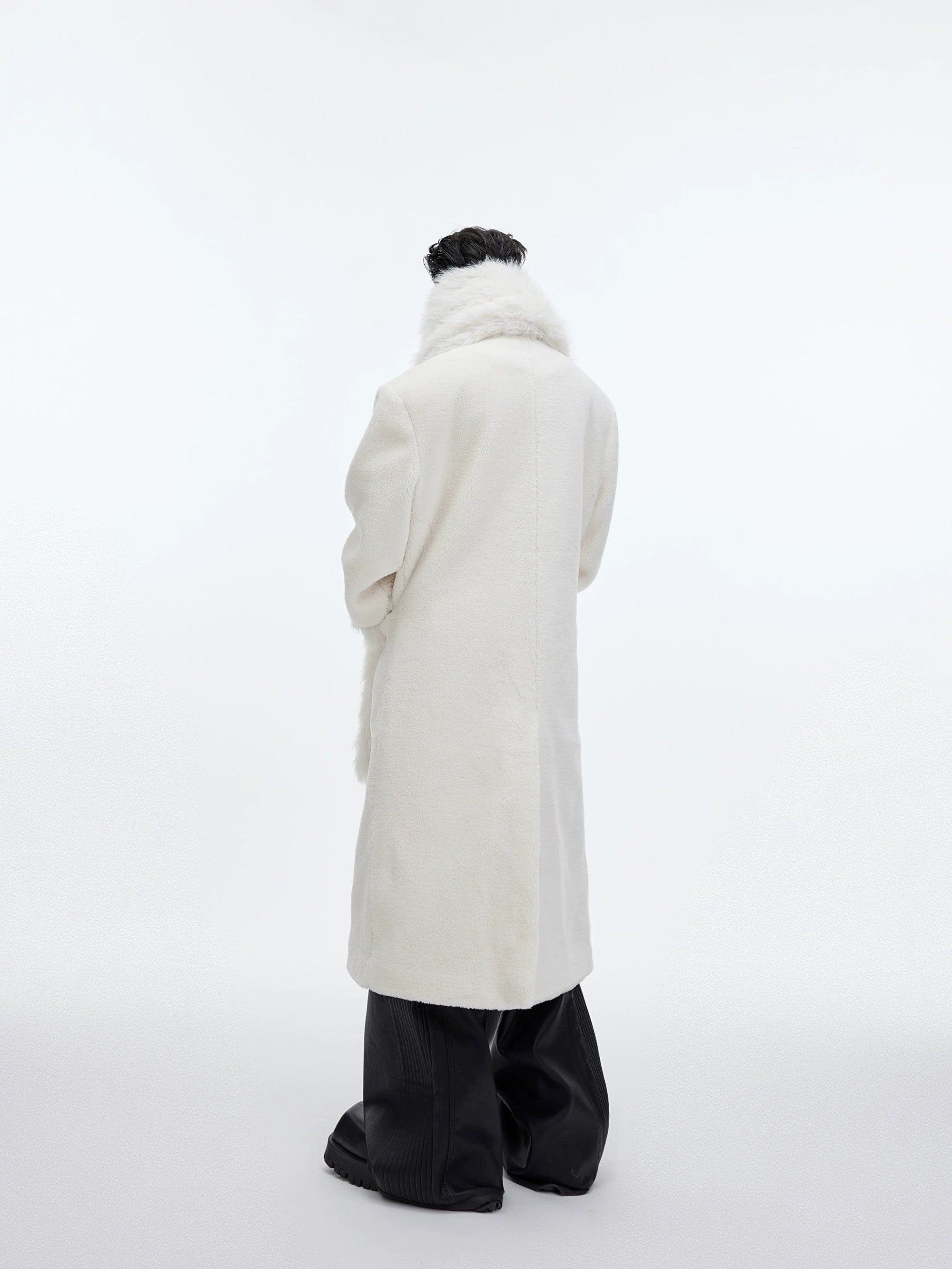 Close up of the detachable scarf and leather branding on wool coat
