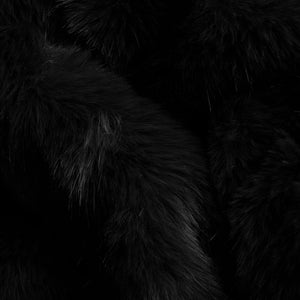 Detail shot of the lapel and button closure on the striped cardigan.