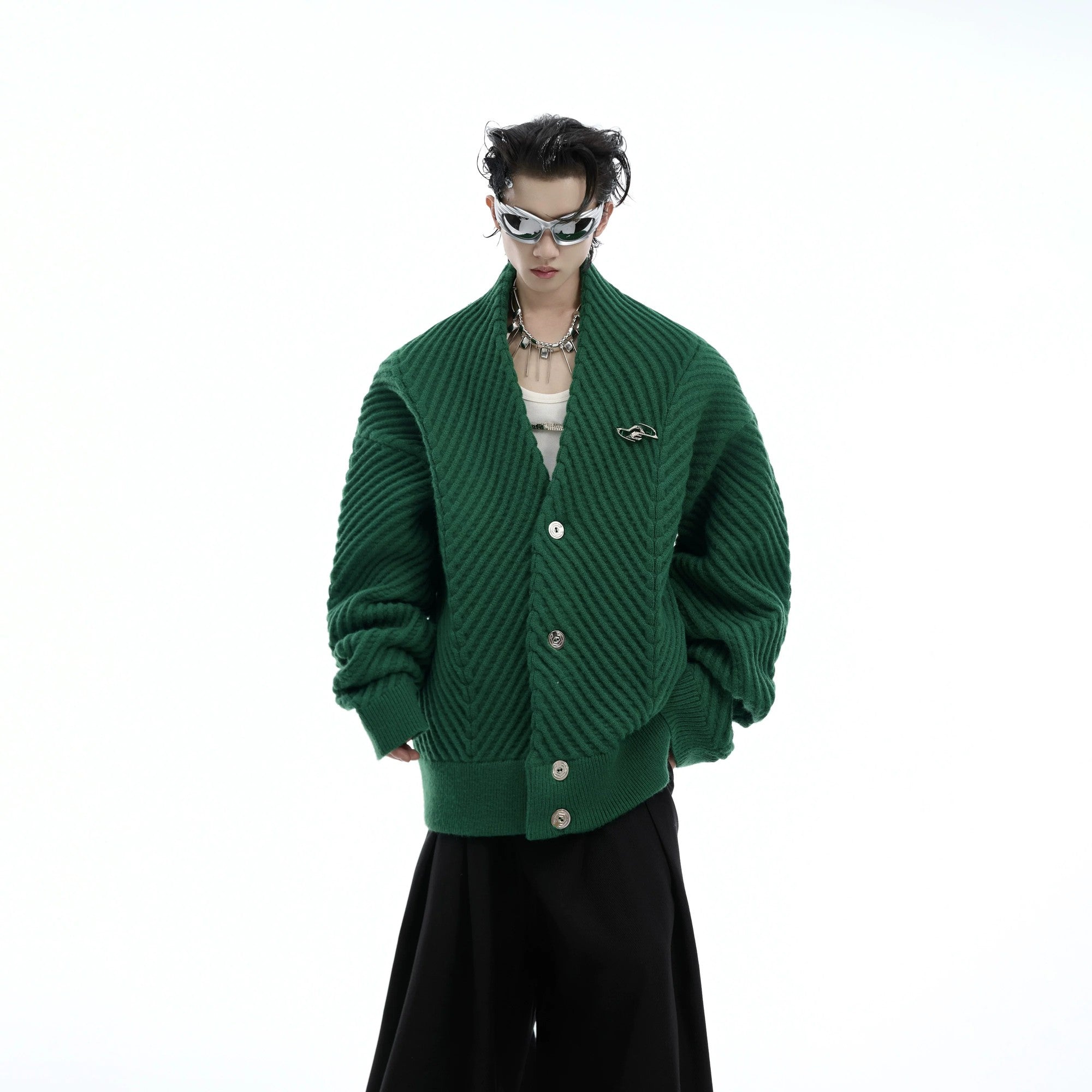 Close-up of premium metal buttons on a white chunky knit cardigan