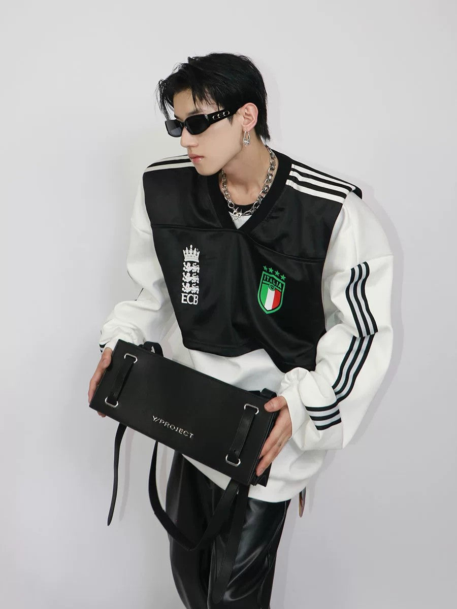 Front view of men's padded shoulder patchwork fake two-piece sweatshirt in black and white