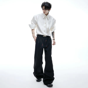 Unisex model wearing the padded shoulder tie shirt with baggy jeans