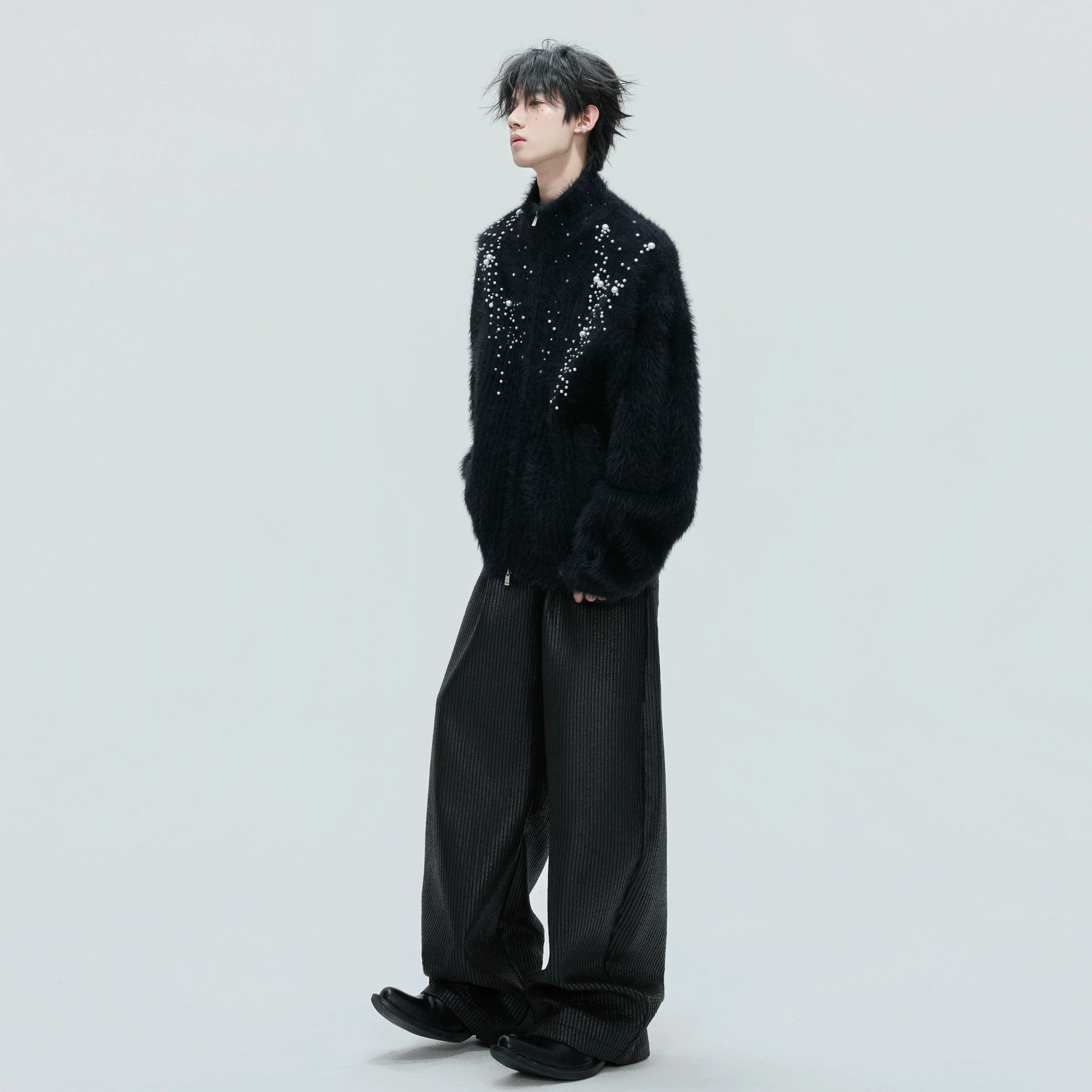 Detail shot of hand-placed pearls on premium wool fabric