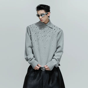 Front view of black heavyweight pearl embellished cable knit sweater