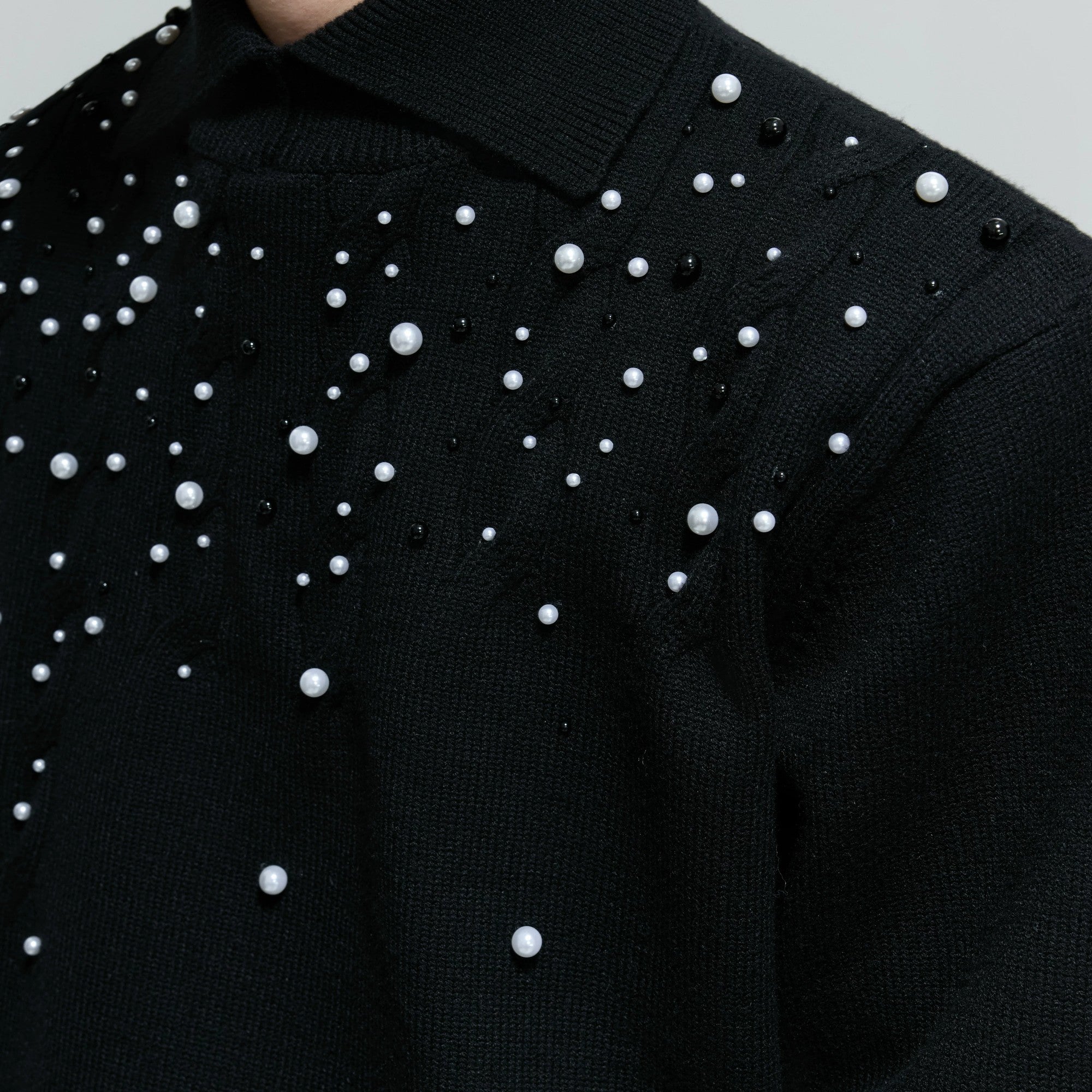 Side view showing the loose fit of the gray pearl knit sweater