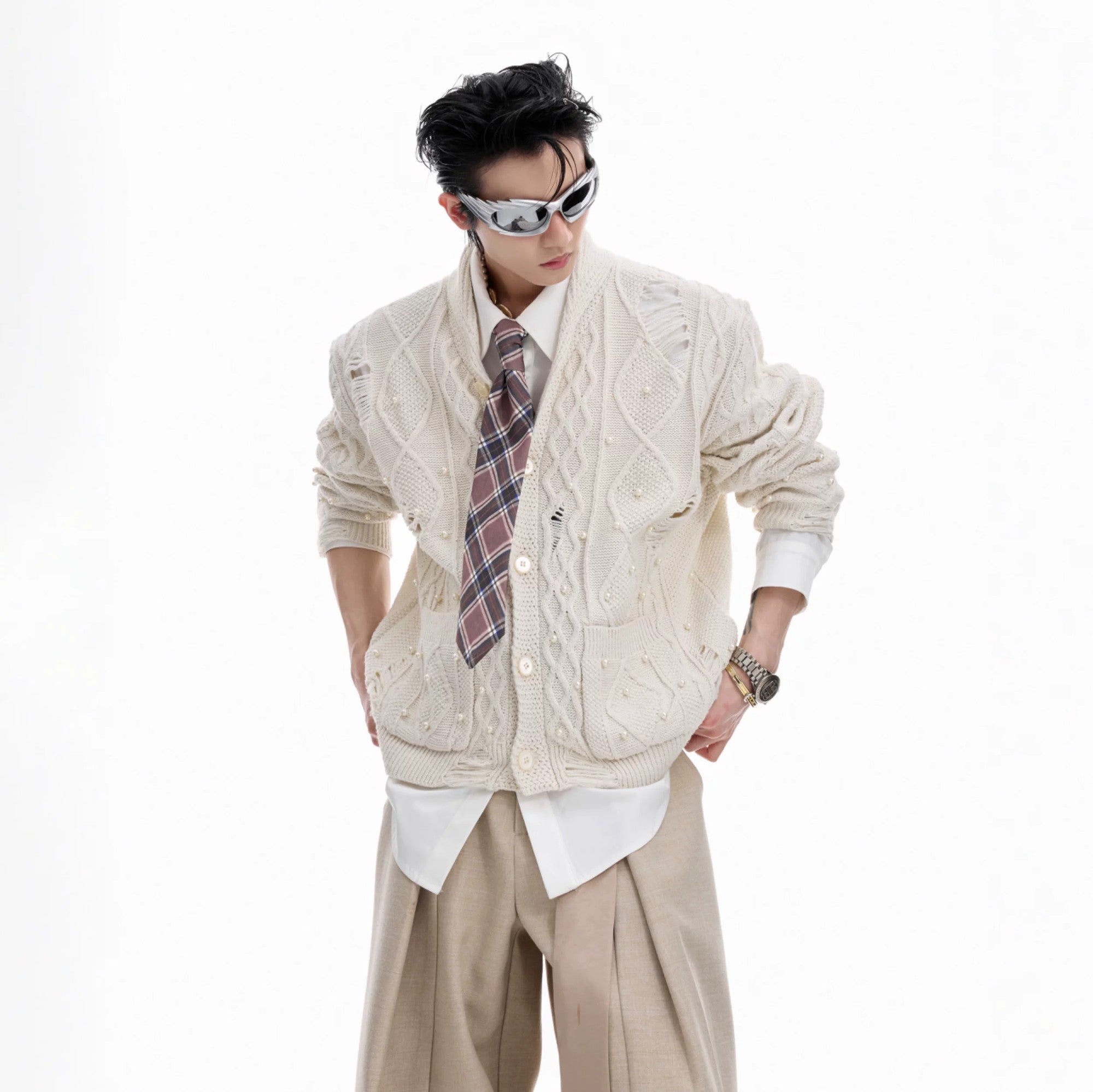 Close up of apricot pearl distressed knit cardigan with hollow grid design