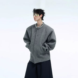 Close up of pearl embellishments on the neckline of a knit cardigan