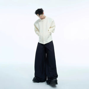 Display of pearl cardigans in white, gray, red, and black