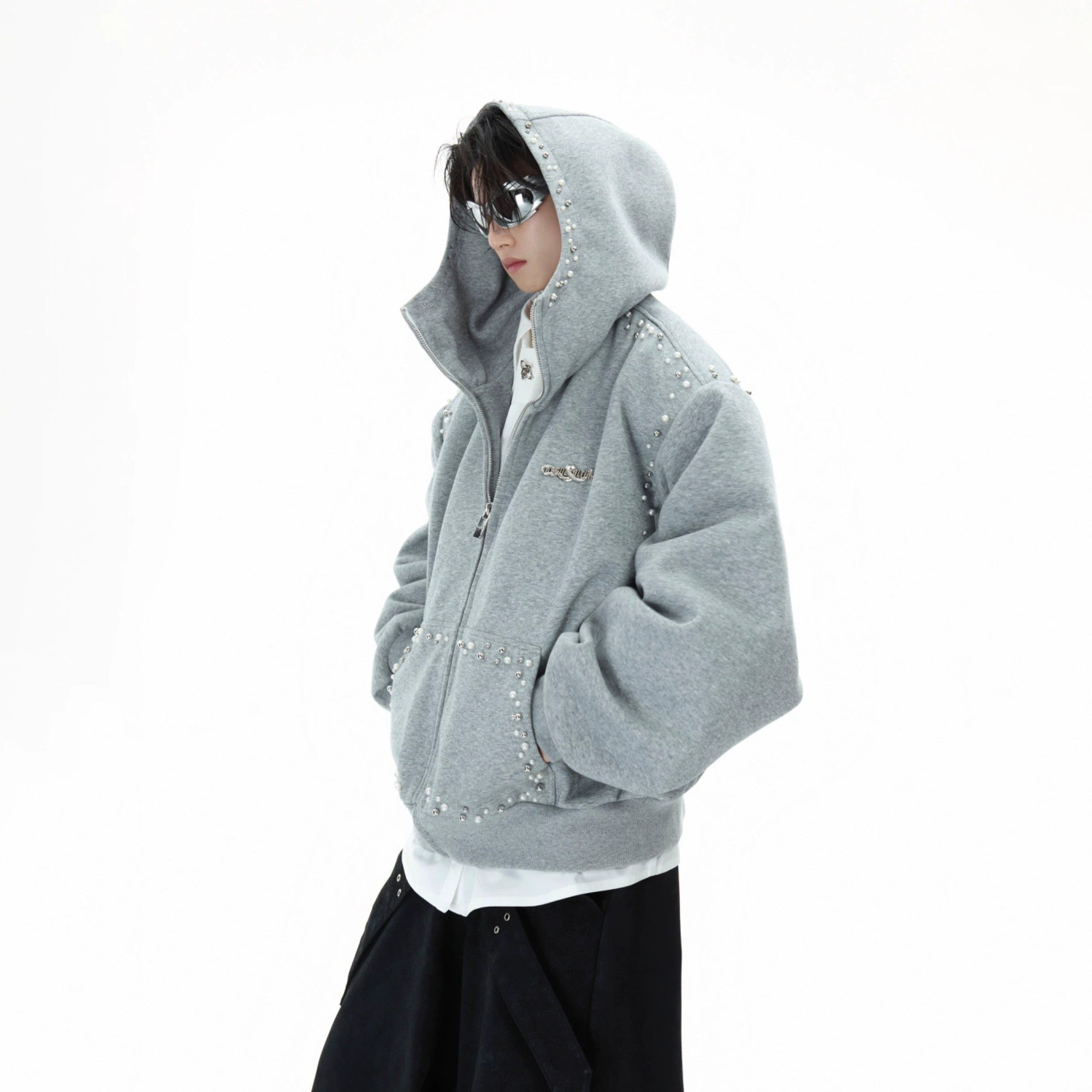 Front view of a loose black pearl-trimmed zip-up streetwear hoodie