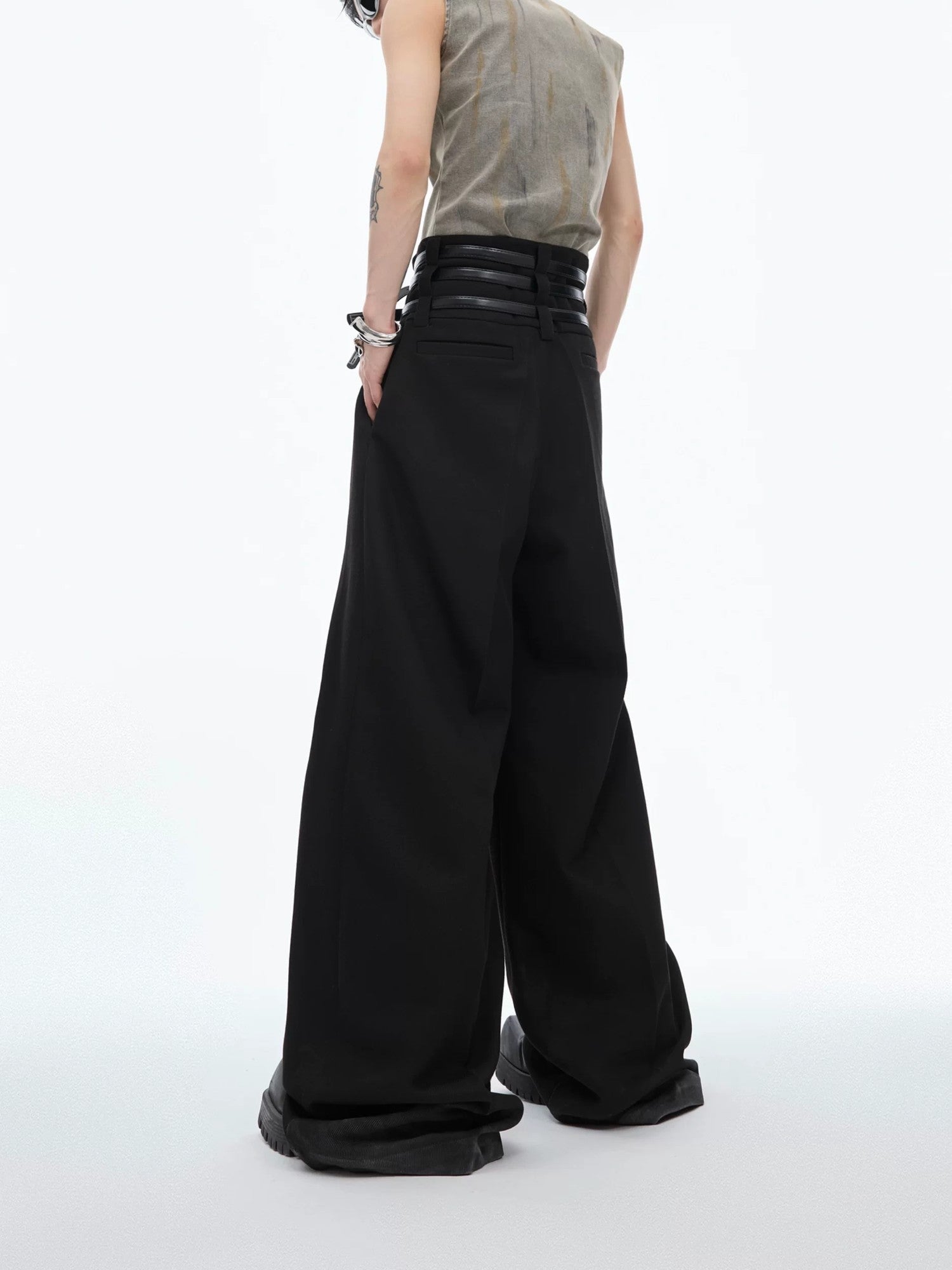 Model wearing black pleated trousers in a minimalist streetwear style